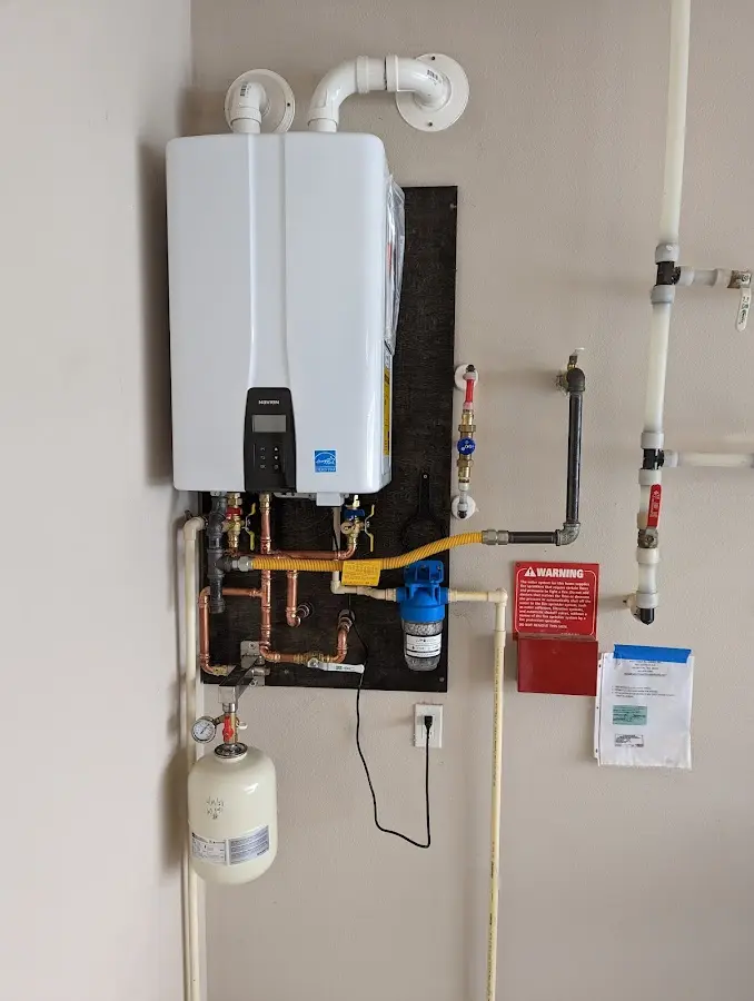 Professional plumber installing copper piping in a Jasmine Estates home